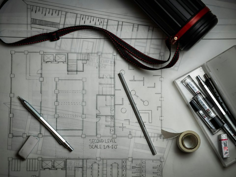 Architectural drawings with drafting pencils and a metal ruler