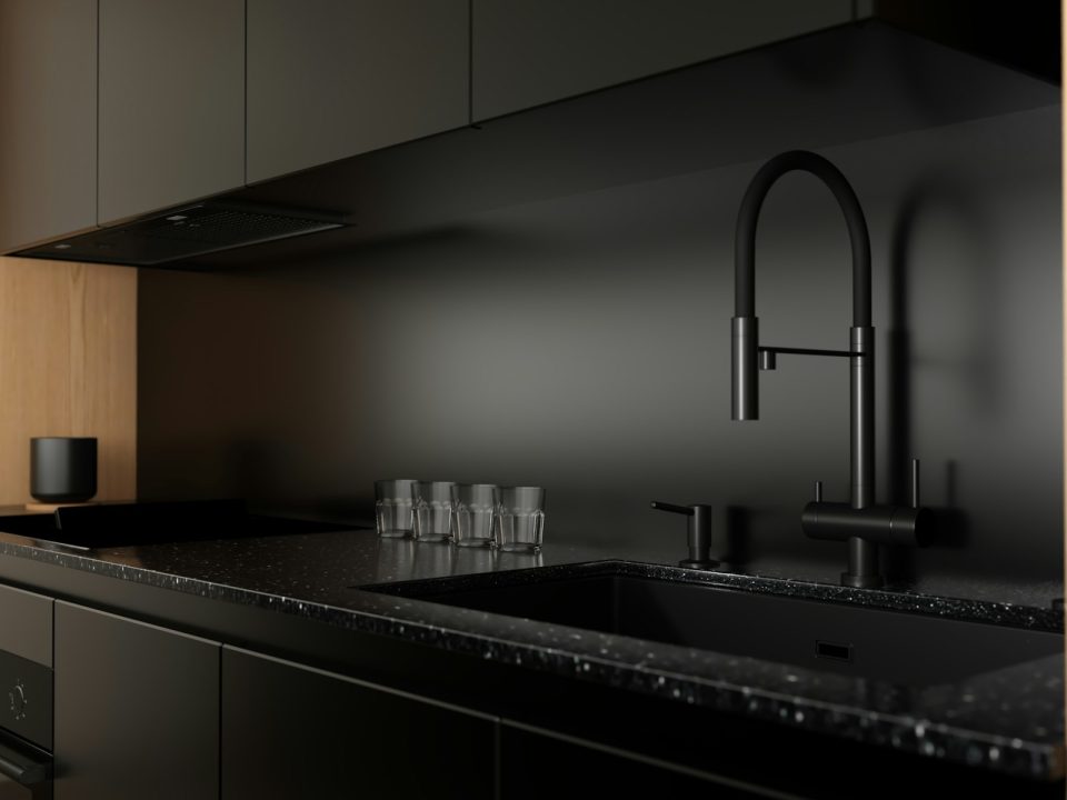 Matte black kitchen cabinetry with oak details and soft daylight