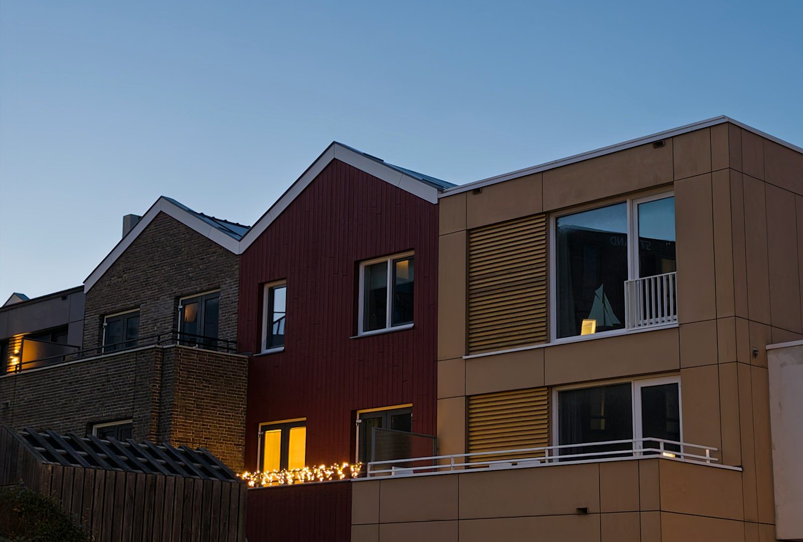 Modern attached homes illuminated at dusk