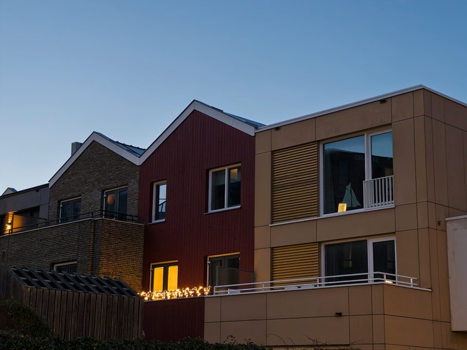 Modern attached homes illuminated at dusk