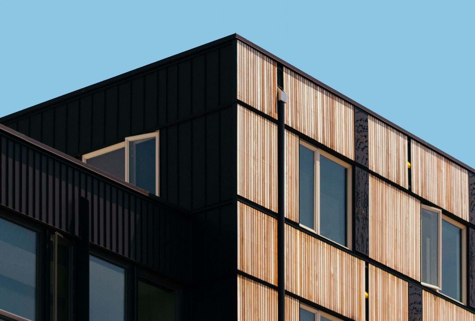 Brick and dark-panel facade of a mid-rise residential building