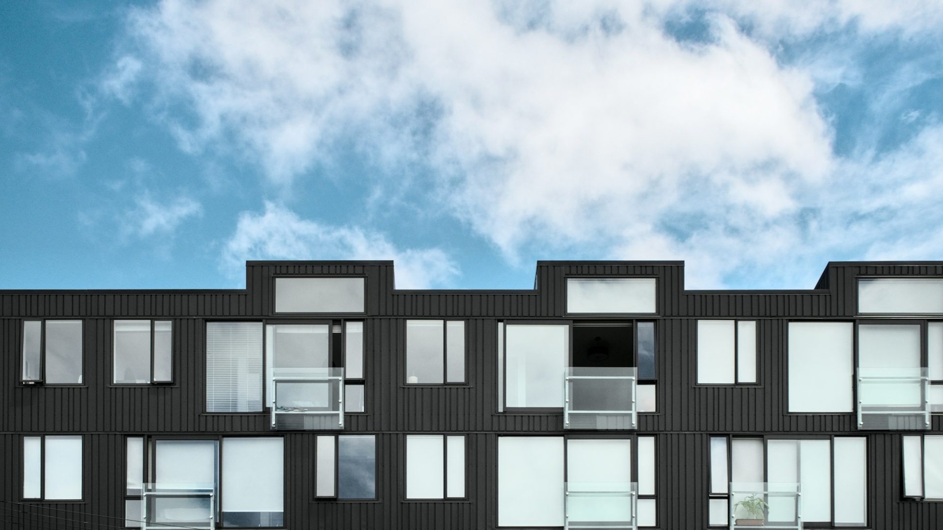 Modern multi-storey apartment building facade (illustrative image)