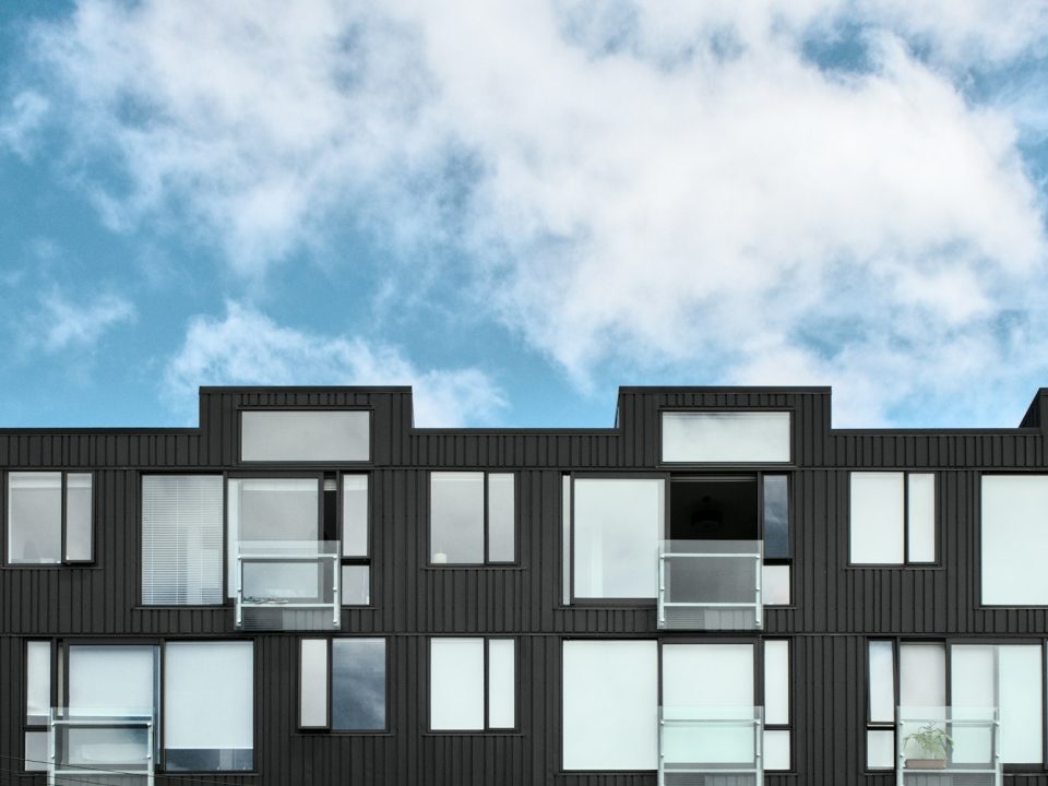 Modern multi-storey apartment building facade (illustrative image)